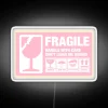 Eye-catching pink neon sign with fragile alert warning message