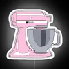 Neon sign advertising colorful electric mixer in pastel pink hues
