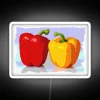 Eye-catching Neon Sign Featuring Colorful Posterized Pepper Fruit Pair Design