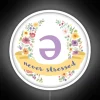 Neon floral sign with calming schwa design in RGB colors