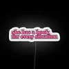 Colorful pink RGB LED sign reading 'She Has A Book'