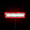 Empowering womanhood over traditional masculinity in neon bold letters.