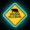 Brightly lit 'Speeding Kills Bears' speed bumper sign with colorful design