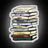 Neon LED light displays vibrant colors on book stack silhouette