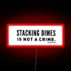 Neon warning sign with colorful phrase about coin stacking legality