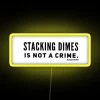 Vibrant LED Sign with Whimsical Warning Message about Coin Stackings