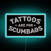 Quirky Tattoo Shop Decor with Humorous 'Tattoos are for scumbags' Sign