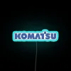 RGB Neon Sign: Komatsu Factory Construction Site Illuminated Background Design