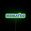 Neon industrial signage featuring colorful Komatsu factory construction design accents