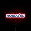 RGB illuminated neon sign featuring Komatsu factory construction design.