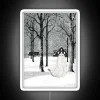 Spooky Neon Sign Featuring Ghostly Figure Amidst Winter Snow Storm