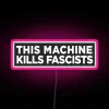 RGB neon sign with bold 'This Machine Kills Fascists' artwork statement.