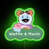 Neon sign featuring colorful waffle and mochi design with glow.
