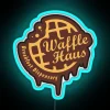 Vibrant Waffle Haus neon sign in RGB electric colors