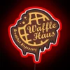Vibrant RGB neon sign advertising the breakfast eatery Waffle Haus classic.