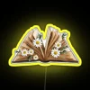 Whimsical watercolor open book with delicate flower RGB neon signage.