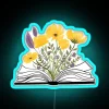 Vibrant watercolor floral open book neon sign in bright yellow colors.