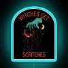 Magical witch-themed neon sign with humorous warning and colorful accents.