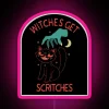 Whimsical neon sign featuring witches with itchy magic spells