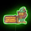 Woodsy owl silhouette glows brightly in vibrant electric RGB lights