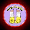 Neon Accent Wall Sign Featuring Yellow Crocs and Rainbow Socks