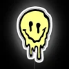 Brightly lit yellow smiling emoji face in vibrant neon glow.