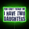 Empowering feminist home decor with bright 'You Can't Scare Me' neon signs.