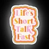 rgb neon sign displaying a vibrant and colorful "life is short" message