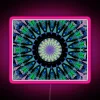 looking-up-through-fir-trees-with-rgb-neon-pink-sign