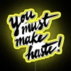 Neon RGB 'Make Haste' sign in vibrant yellow.