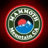 Skiing, snowboarding, hiking, and climbing at Mammoth Mountain in California, featuring a vibrant neon sign.