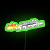 rgb neon sign displaying 'meanwhile in the flute section' with vibrant green lighting.