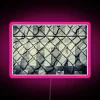 An RGB neon sign displaying a vibrant pink mesh design.