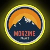 A vibrant neon sign displaying a mountain design in Morzine, France, illuminated with RGB lighting and yellow tones.