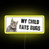 Child eating bugs neon-style rgb sign with bright yellow glow.
