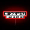 rgb neon sign displaying 'my code works i have no idea why' - mysterious coding success message in red glow.
