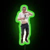 nerdy boy dancing to rgb neon sign with 'nasty' in green glow.