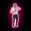 nerdy boy dancing with an rgb neon sign with pink glow