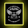Never underestimate an old man on a motorcycle - neon sign in vibrant-RGB colors with yellow highlights.