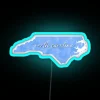 north carolina neon sign with tie-dye rgb design featuring vibrant blue glow