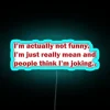 RGB neon sign displaying 'Not Joking I'm Mean' with a blue background.