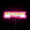 A colorful neon sign displaying 'Our Family: A Little Bit of Crazy' with vibrant RGB lighting.