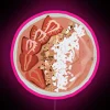 Neon-lit pink smoothie bowl sign.