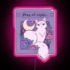 Neon sign displaying Play All Night in RGB colors with a pink glow.