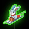 Playful bunny sledding on a gift box lid with RGB neon sign.