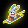 A playful bunny sledding on a gift box lid with an RGB neon yellow sign.