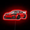A stunning Porsche GT2 RS with an RGB neon sign highlighting its modern design in vibrant red.
