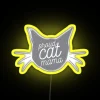 proud cat mama poses confidently with a dusty gray neon sign