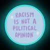 Neon sign stating 'Racism Is Not A Political Opinion' - promoting racial justice and equality awareness.
