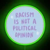 neon sign saying 'racism is not a political opinion' in rgb colors, green version.